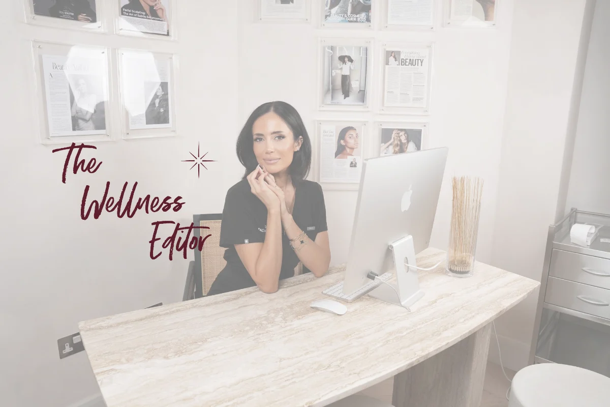 The Wellness Editor masthead beside Dr Nina Bal at her consultation desk